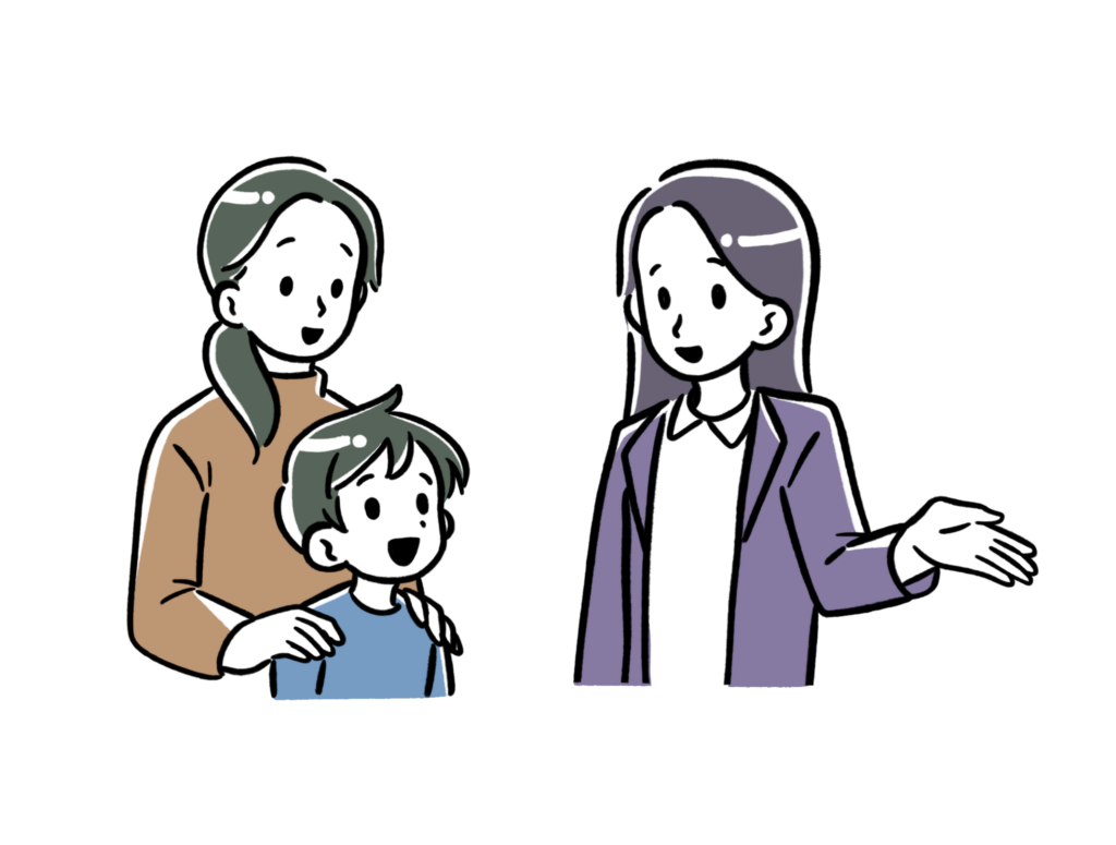 無料体験に来た小さい男の子とお母さんを女性の先生が案内している